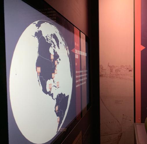 a touch screen with a spherical projection of a world map